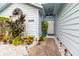Inviting front entrance with decorative landscaping and a light-colored exterior at 9355 Telfer Run, Orlando, FL 32817