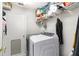Functional laundry room featuring modern washer and dryer units, storage shelving, and convenient access at 9355 Telfer Run, Orlando, FL 32817