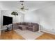 Comfortable living room with hardwood floors, a ceiling fan, and ample natural light at 9355 Telfer Run, Orlando, FL 32817