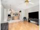 Spacious living area featuring hardwood floors and an open layout connecting to the kitchen at 9355 Telfer Run, Orlando, FL 32817