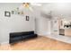 The spacious living room features wood floors and connects to a tiled area with a stainless steel dishwasher at 9355 Telfer Run, Orlando, FL 32817