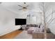 Cozy living room featuring hardwood floors, comfortable seating, and large windows for natural light at 9355 Telfer Run, Orlando, FL 32817