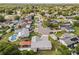 Shows a neighborhood layout featuring various houses, greenery, and a swimming pool in one of the backyards at 955 Tomes Ct, Orlando, FL 32825