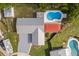 Aerial shot of a house featuring a pool, a deck with an inset portion, and diverse yard areas at 955 Tomes Ct, Orlando, FL 32825