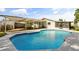 Features a swimming pool with a unique design and a covered patio area, with access to the home's back entrances at 955 Tomes Ct, Orlando, FL 32825