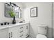 Modern bathroom featuring dual sinks with black hardware and a large mirror at 955 Tomes Ct, Orlando, FL 32825