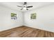 Empty bedroom with hardwood floors, a modern ceiling fan, and two windows at 955 Tomes Ct, Orlando, FL 32825