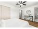 Bright bedroom with hardwood floors, a modern ceiling fan, and an ensuite bathroom at 955 Tomes Ct, Orlando, FL 32825