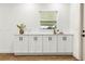 Counter featuring white cabinets and a window at 955 Tomes Ct, Orlando, FL 32825