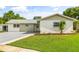 Charming single-story home boasting a metal roof and a lush, green lawn at 955 Tomes Ct, Orlando, FL 32825