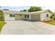 Well-maintained single-story home featuring a spacious driveway and attached garage at 955 Tomes Ct, Orlando, FL 32825