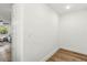 Hallway featuring wood flooring and a white wall at 955 Tomes Ct, Orlando, FL 32825
