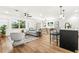 Open-concept living room with a view of the modern kitchen and dining area at 955 Tomes Ct, Orlando, FL 32825