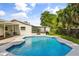 Backyard with a large swimming pool and patio area, complemented by surrounding landscaping and a glimpse of the home at 955 Tomes Ct, Orlando, FL 32825
