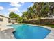 Exterior view showcasing a backyard with a large pool, patio, and lush landscaping, enhancing the outdoor living space at 955 Tomes Ct, Orlando, FL 32825
