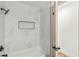 Modern shower featuring white marble tiling and black hardware with glass door access at 955 Tomes Ct, Orlando, FL 32825
