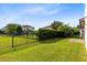 Green backyard featuring a well-maintained lawn and partial fence at 9978 Mere Pkwy, Orlando, FL 32832