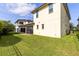 Spacious backyard featuring a well-maintained lawn, screened in lanai, and partial fence at 9978 Mere Pkwy, Orlando, FL 32832