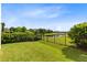 Well-manicured backyard with beautiful green grass and a view of the pond at 9978 Mere Pkwy, Orlando, FL 32832