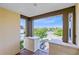 This balcony offers a beautiful view of the surrounding neighborhood, including lush greenery and a community pool at 9978 Mere Pkwy, Orlando, FL 32832