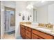 This spacious bathroom features a double vanity and a shower-tub combo at 9978 Mere Pkwy, Orlando, FL 32832
