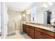 Beautiful bathroom featuring tiled floors, a double vanity, and a glass-enclosed shower at 9978 Mere Pkwy, Orlando, FL 32832