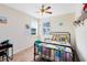 This bright bedroom features neutral walls, natural lighting, and a colorful bed at 9978 Mere Pkwy, Orlando, FL 32832