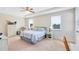 Bright bedroom with tray ceilings, two windows, and neutral carpet flooring at 9978 Mere Pkwy, Orlando, FL 32832
