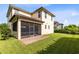 This two-story home features a screened-in patio, a well-maintained lawn, and mature landscaping at 9978 Mere Pkwy, Orlando, FL 32832
