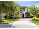 Charming two-story home with a well-manicured lawn, brick driveway, and inviting entrance at 9978 Mere Pkwy, Orlando, FL 32832