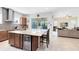 Open kitchen with granite island, beverage cooler, and seamless flow to the living area at 9978 Mere Pkwy, Orlando, FL 32832