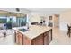 Bright kitchen island with sleek countertops, sink, stainless appliances, and outdoor access at 9978 Mere Pkwy, Orlando, FL 32832