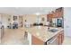 Modern kitchen island with sink, stainless steel appliances, and adjacent dining area at 9978 Mere Pkwy, Orlando, FL 32832