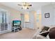 Upstairs loft area with neutral carpet, balcony access, and comfortable seating at 9978 Mere Pkwy, Orlando, FL 32832