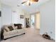 Upstairs loft with neutral carpet, a cozy couch, and ample storage space at 9978 Mere Pkwy, Orlando, FL 32832