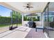 This covered patio features brick flooring, a ceiling fan, and a grill, perfect for outdoor cooking and entertainment at 9978 Mere Pkwy, Orlando, FL 32832