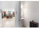 Modern powder room with a pedestal sink and a view of the kitchen beyond at 9978 Mere Pkwy, Orlando, FL 32832