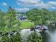 Stunning lakefront home featuring a boat house, lush landscaping, and a private swimming pool at 339 Carolyn Dr, Oviedo, FL 32765
