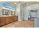 A bathroom with a dual vanity, tiled floors, and a partial view of the bedroom at 339 Carolyn Dr, Oviedo, FL 32765