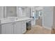 Bathroom vanity with bowl sink, white cabinets, and view of the bedroom at 339 Carolyn Dr, Oviedo, FL 32765