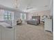 Spacious bedroom with carpet floors, chandeliers, light-colored walls, and a large bed at 339 Carolyn Dr, Oviedo, FL 32765