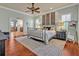 Bright bedroom with a metal bed frame, ceiling fan, a nightstand, and an ensuite bathroom at 339 Carolyn Dr, Oviedo, FL 32765