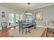 Dining room with modern lighting and sliding glass doors overlooking the pool at 339 Carolyn Dr, Oviedo, FL 32765