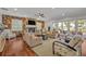 Bright living room featuring a stone fireplace, ceiling fan, and sliding glass doors to the outside at 339 Carolyn Dr, Oviedo, FL 32765