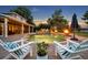 Stunning in-ground pool with lounge chairs, patio, fire bowls, and lush landscaping at 339 Carolyn Dr, Oviedo, FL 32765