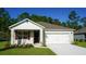 Charming single-Gathering home featuring an attached two-car garage and a well-manicured lawn at 1055 Morfontain St, Daytona Beach, FL 32124