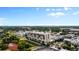 An aerial view of a multi-story building near a green area and train tracks at 111 E Monument Ave # 801, Kissimmee, FL 34741