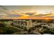 Aerial view of the building in a city setting, with trees and a sunset sky in the background at 111 E Monument Ave # 801, Kissimmee, FL 34741