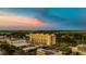 An aerial view of a building with sunset, set amongst a scenic cityscape at 111 E Monument Ave # 801, Kissimmee, FL 34741