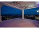 Covered outdoor balcony featuring ceiling fans, column supports, iron railings, and city views at 111 E Monument Ave # 801, Kissimmee, FL 34741
